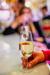 Hand Holding Fino Sherry at a Seville Tavern