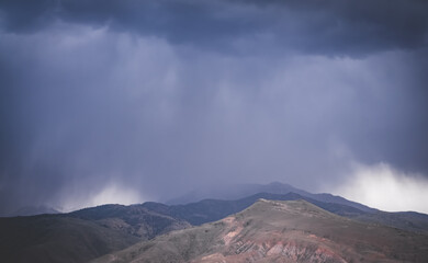 Cloudy rainy weather with clouds in the mountains, heavy rain and water pouring from the sky, rainy...