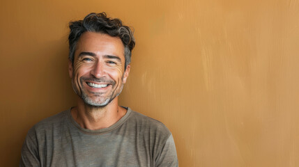Fototapeta premium A man with a big smile on his face is standing in front of a wall