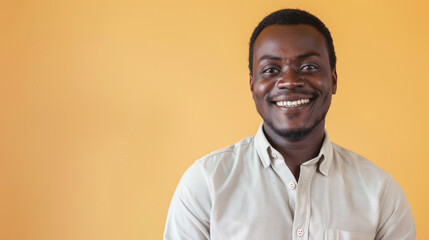 Fototapeta premium A smiling man with a beard and a white shirt is posing for a picture