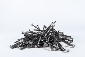 a pile of iron long nails on a white background