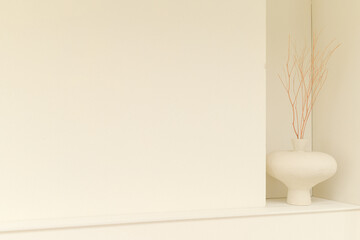 white wall with white vase