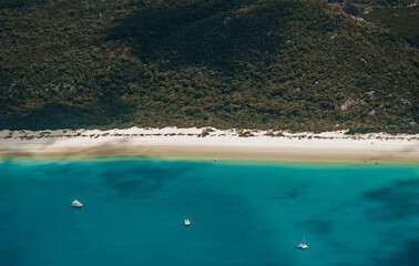 Whitehaven beach with a sailing boat in the foreground