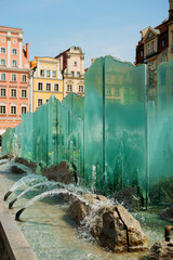 Medieval market square in Wroclaw, Poland. Beautiful glass Wroclaw fountain on the market square....