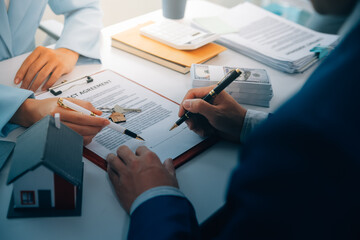 Real estate agent talked about the terms of the home purchase agreement and asked the customer to sign the documents to make the contract legally, Home sales and home insurance concept.