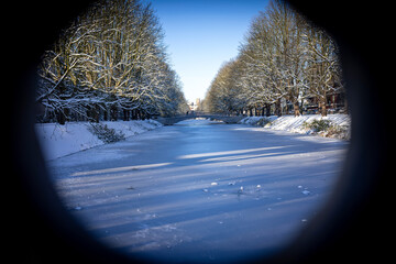 Unique Circular Frame View of Clarenbachkanal in Winter, Cologne: A frozen and snow-covered canal...