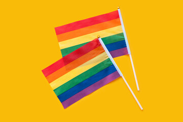 LGBT rainbow flag flat lay on yellow color background. gay marriage, human rights, june parade,...