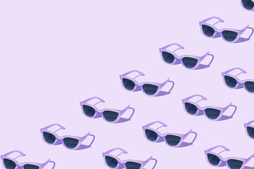 Pattern made of purple sunglass on violet baclground. Creative pattern.
