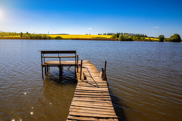 place for fishing and relaxing by the river on a summer day.