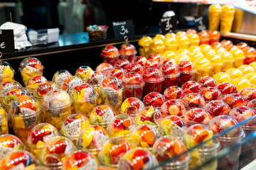 Fruit Salad arranged in plastic cups on a market. Cut and ready fruit ready to sell in market....