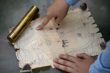 A quest in search of pirate treasures. Active outdoor games with children.An old pirate map showing the treasure.