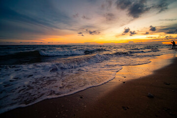 Aerial panorama of Thailand's verdant with blue and aquamarine the sea, and clouds shining by sunlight in the background.