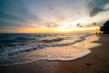 Aerial panorama of Thailand's verdant with blue and aquamarine the sea, and clouds shining by sunlight in the background.