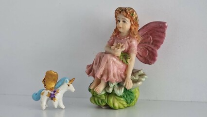 the girl with a doll. the fairy with a unicorn 