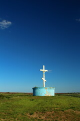 A small blue container with a cross on top of it