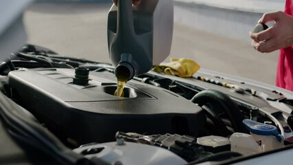 Mechanic pours automotive oil car lubrication engine work car maintenance auto service. Mechanic attends vehicle professionalism reliable automotive services oil change repair auto service.