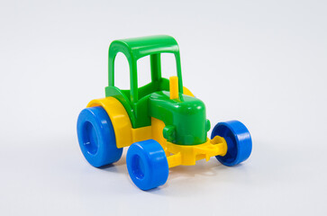 Plastic toy tractor on a white background.