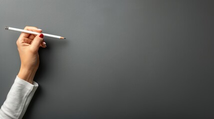   A woman's hand, holding a cigarette, in front of a gray wall with an extended cigarette