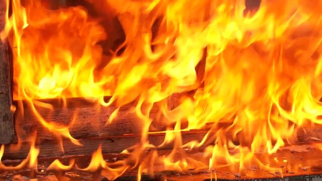 Wooden house burning. Close up of building with massive flames. Wooden house on the huge fire. Fire in an abandoned house the poor
