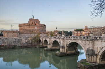 A beautiful bridge stretches over a serene river, leading towards a grand castle in the background....