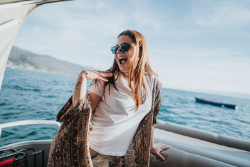 Happy young woman with open arms feeling joyful on a leisure boat trip, embracing the sea breeze.