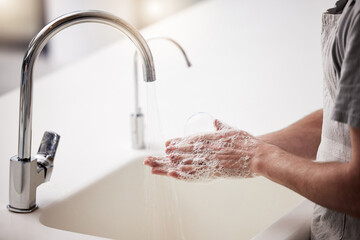 Hands, washing and water with soap in house for hygiene with wellness for cleanliness. Bathroom,...