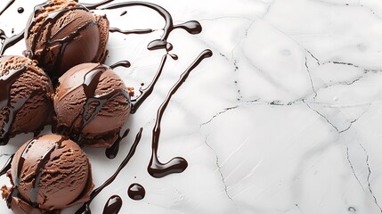 Scoops of brown ice cream with chocolate syrup on white stone background