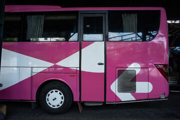 Purple tourist bus side view