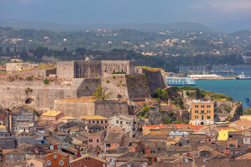 Scenic view of Kerkyra, Corfu, Greece, and harbor from Old Fortress, with fortress walls and cliffs