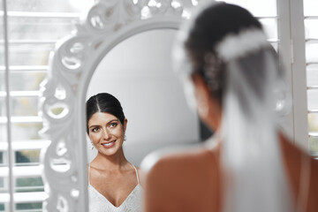 Bride, wedding and smile on mirror for reflection, happy and prepare for ceremony celebration....