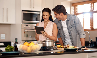 Couple, kitchen and cooking with online video on tablet, wellness and nutrition. Marriage, man and woman cut or read instructions on the internet, food website or blog and prepare meal for dinner - Powered by Adobe