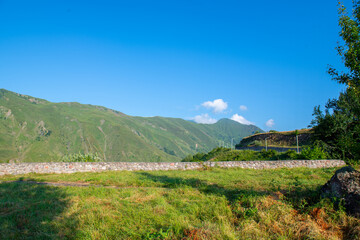 Majestic Greens and Azure Bliss: Mountains and Skies in Harmony