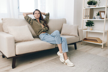 Cosy Apartment: Relaxing Woman on Modern Sofa in Happy Home.