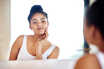 Skincare, beauty and woman at mirror in bathroom for dermatology, wellness and morning routine for...