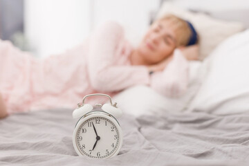 White clock and sleeping woman
