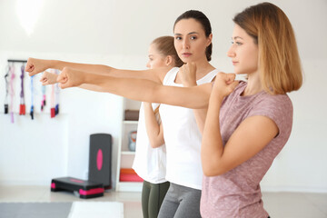 Young women training at self defense courses in gym