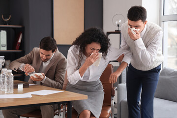 Business people covering faces with wet tissues in burning office building