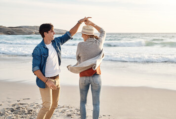 Couple, dancing and happy together on beach, seaside and holiday for relationship bonding and love...