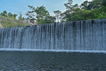 Water fall dam landscape view with clear blue sky background