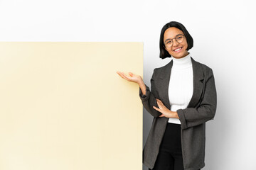 Young business mixed race woman with with a big banner over isolated background holding copyspace...