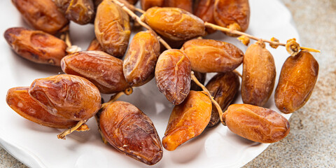 date on a branch dried sweet fruit fresh meal food snack on the table copy space food background...