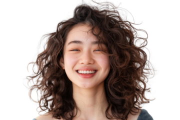 Young woman with long, curly hair smiling isolated on transparent background. She is wearing a white shirt and has a happy expression on her face .