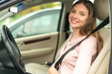 Young pretty blonde woman inside a car