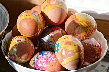 Easter eggs decorated with patterns in a plate, on a domestic kitchen. Orthodox Easter in eastern Europe.