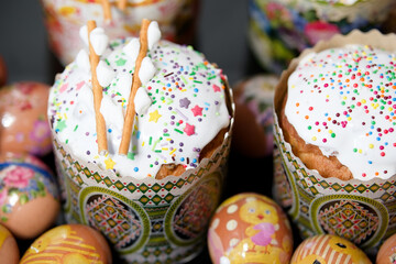 Composition of easter cakes with protein glaze, sugar sprinkles, marshmallow on top and eggs...