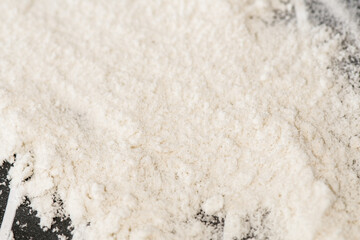 White flour sprinkled on a table, prepared for cooking a cake. Domestic kitchen