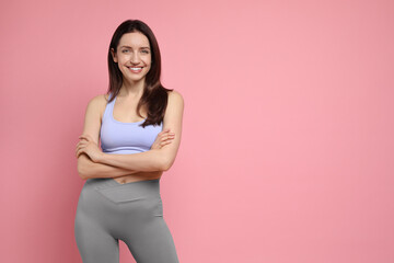 Happy young woman with slim body on pink background, space for text