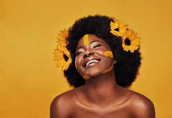 Black woman, studio and natural sunflowers for spring, nature skincare and rest with African model and afro. Selfcare, wellness for beauty with organic cosmetics, dermatology on yellow background