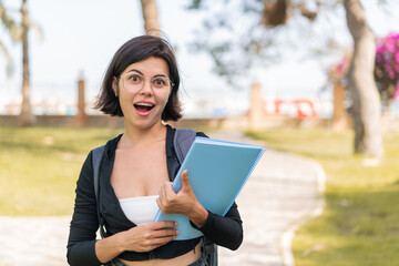 Young Bulgarian student woman at outdoors with surprise and shocked facial expression