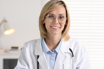 Portrait of smiling doctor on blurred background